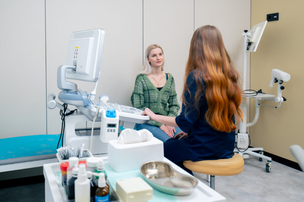 Bloomfield urgent care clinic in the clinic a young blonde girl at an appointment with a gynecologist consultation before the examination
