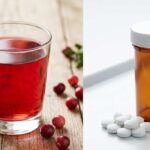 A side-by-side comparison showing a glass of cranberry juice with fresh berries on the left and a prescription pill bottle with white tablets on the right, illustrating A+ Urgent Care's guide to home remedies versus antibiotics for UTIs.