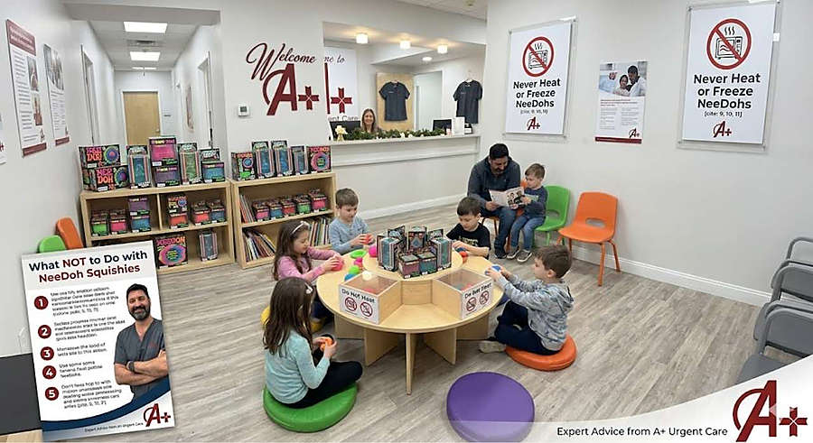 A+ urgent care waiting room where children play with needoh toys at a round table, featuring safety warning posters on the walls and a health alert graphic in the foreground.