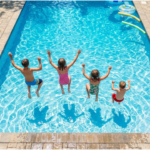 Kids enjoying the summer jumping in the pool